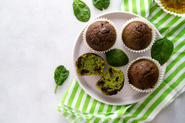 Spinach muffins. Healthy, vegan green muffins, top view. Copy space