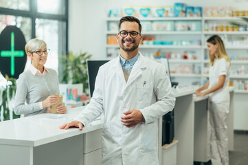 Young female pharmacist posing while working in a pharmacy