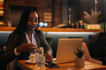 Businessman working on his laptop while drinking coffee in a cafe