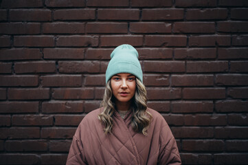 Beautiful young stylish woman wearing coat and a cap