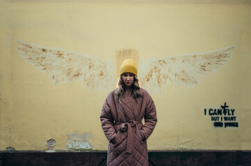 Beautiful young stylish woman wearing coat and a cap