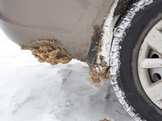 dirty snow on the fenders of the car