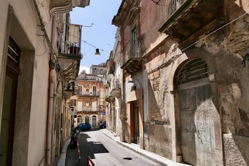 Narrow scenic street in Baroque town Ragusa with traditional townhouses, UNESCO World Heritage Site. Sicily, Italy.