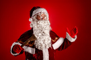 santa claus with ring bell portrait against red background