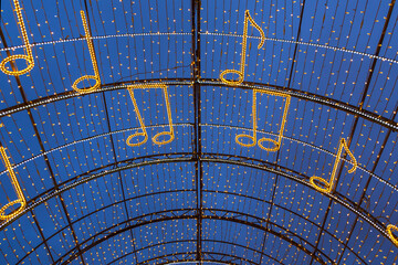 Christmas decoration with garlands of a city street in the form of notes