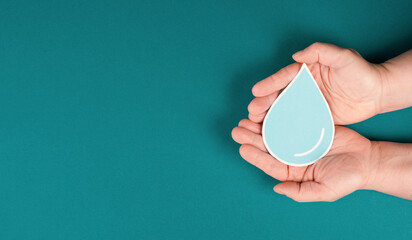 Hands holding a drop of water, paper cut out, environmental issue, copy space for text