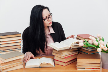 beautiful brunette woman at her desk with books for learning