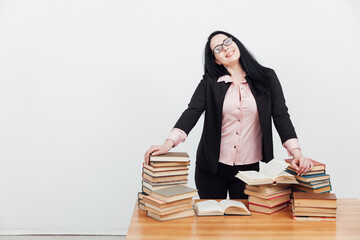 beautiful female teacher at the desk with books for learning