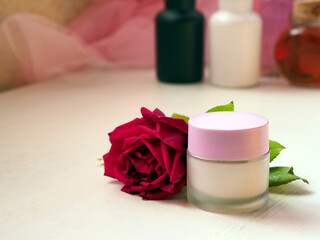 Jar of cream, red rose and beauty products. Routine beauty concept