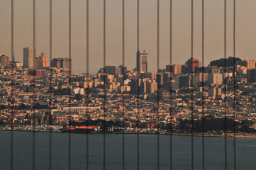 A view of San Francisco skyline through the cables of the Golden Gate Bridge, California, USA