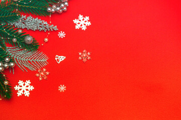Top view of a flat lay of Christmas decorations on a red background. Concept postcard, announcement, banner. With copy space