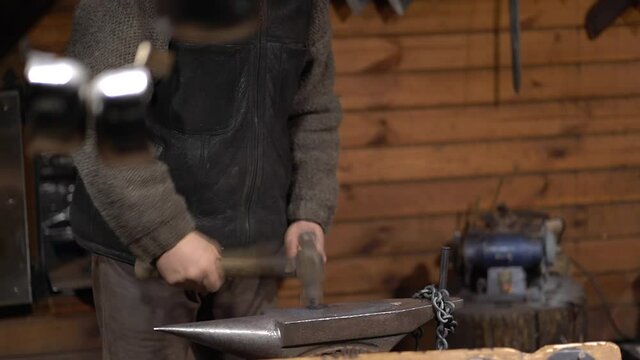 Blacksmith using a hammer at work