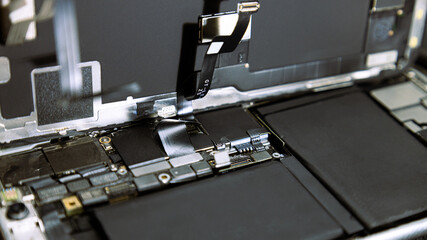 Disassembled smartphone on a dark background, phone repair and cleaning