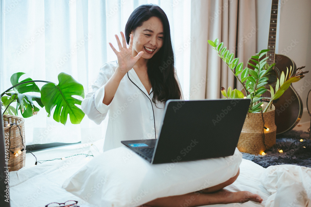 Wall mural young asian woman using laptop computer to business online work, female freelance working from home 