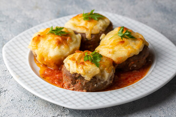 Turkish Food Hasanpasa Kofte - Kofta with Puree - Meatball with Bechamel Sauce and Green Peas. Traditional Food.