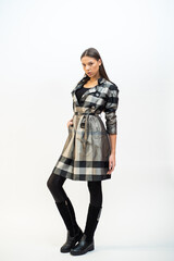 Fashion woman wearing coat and posing on white background