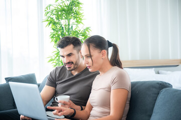 Fototapeta premium woman and man couple working online with laptop for business work at home, happy indoor lifestyle