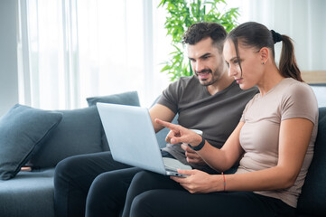 Fototapeta premium woman and man couple working online with laptop for business work at home, happy indoor lifestyle