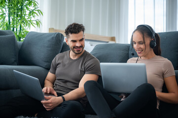 woman and man couple working online with laptop for business work at home, happy indoor lifestyle