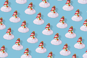 Creative winter pattern with snowman and snow on pasel blue background