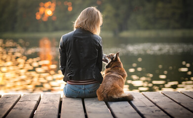Woman dog owner and a dog at the lake