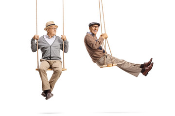 Full length shot of two elderly men swinging on swings