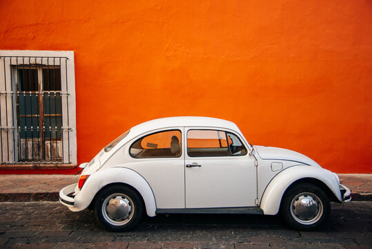 white old Volkswagen near orange wall in mexico - sep, 2019
