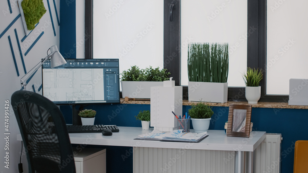 Poster close up of monitor with digital blueprints plans on desk for architecture design of building layout