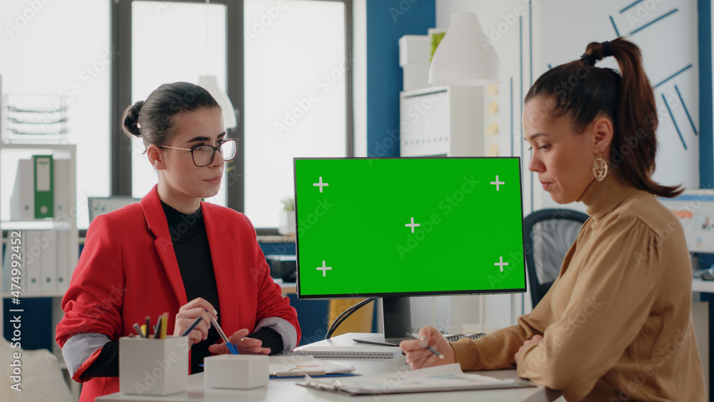 Poster women doing teamwork with isolated green screen on computer in business office. workmates using copy