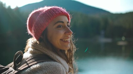 slow motion close up portrait woman tourist sits on wooden pier by beautiful mountain lake and enjoys amazing calm forest landscape. Wild nature beauty, healthy active lifestyle.