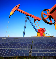 Oil pump with solar panels and the sunset