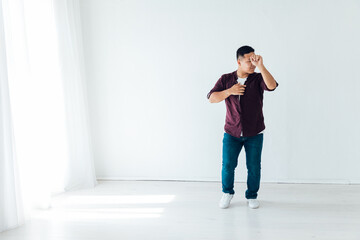 Fototapeta premium man dancing to bachata music in a white hall