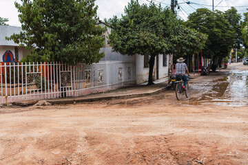 Man riding a bicycle through a Colombian village