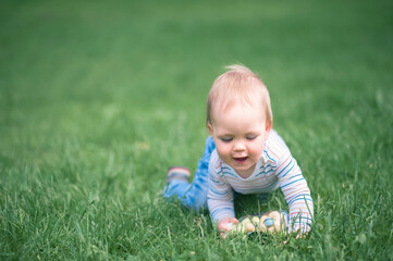 Toddler eggs hunters close-up. Children activity for Easter in nature..