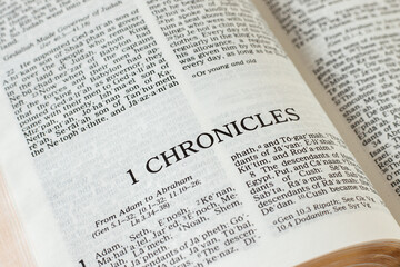 1 Chronicles open Holy Bible Book Old Testament Scripture. Christian prayer, faith, and belief in God Jesus Christ. Biblical study concept. A close-up.