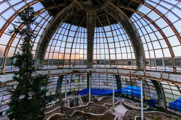 Dome of old abandoned greenhouse winter garden