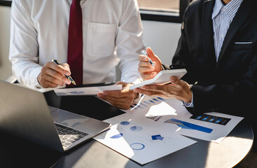 Business managers working with new startup in modern loft.Analyze reports, plans, Business people discussion working concept