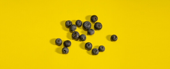 various blueberries on yellow background