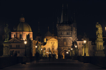 Fototapeta na wymiar Illuminated Charles Bridge in Prague with statues at night.