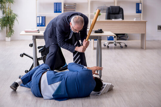 Old boss and young male employee in bullying concept