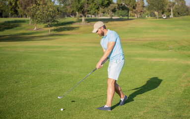 professional male golf player on professional course with green grass, summer