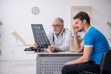 Young male patient visiting old male doctor radiologist