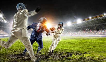 Obraz na płótnie Canvas Businessman acting as american football players . Mixed media