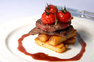 Beef steak with tomatoes and french fries