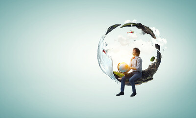 Young man holding a world globe