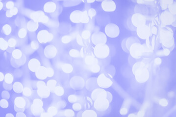 Purple and white blurred garland lights background