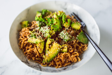 vegan garlic and ginger noodles with avocado and fried onions, healthy plant-based food