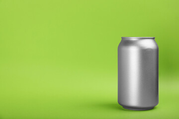 Can of energy drink on green background. Space for text