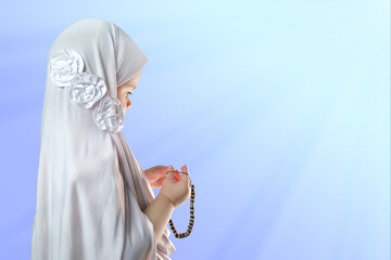 little innocent child, girl in a white hijab against blue background, muslim girl in white dress...