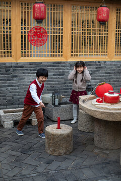 Happy children celebrating Chinese new year with petard